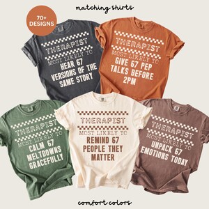 May include: A collection of five Comfort Colors t-shirts in various colors, each with a unique design. The shirts feature the word "THERAPIST" above a phrase like "MOST LIKELY TO HEAR 67 VERSIONS OF THE SAME STORY". The phrase "matching shirts" is at the top.