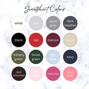 May include: A chart showing 15 different sweatshirt colors, including white, ash, sport grey, dark heather, black, red, maroon, sand, military green, forest green, light blue, navy, dark chocolate, light pink, and safety pink.