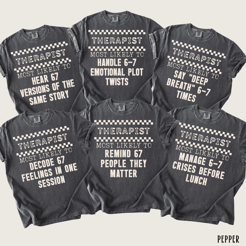 May include: Six dark gray t-shirts with white text and a checkered pattern. Each shirt reads "THERAPIST" and "MOST LIKELY TO" followed by a humorous statement about therapists, such as "HEAR 67 VERSIONS OF THE SAME STORY."