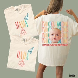 May include: Three ivory t-shirts. Two shirts feature the text MAMA or DADA in colorful gradient letters with a party hat and cake graphic. The third shirt displays the text TWO COOL repeatedly with a child's face and NOAH'S SECOND BIRTHDAY.
