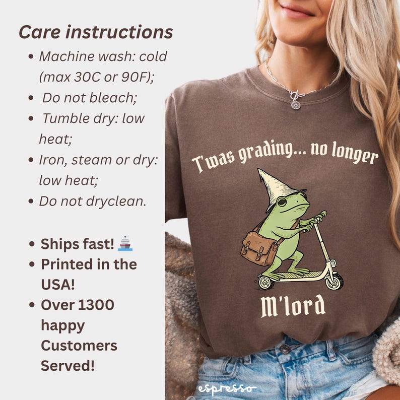 May include: Brown t-shirt with a green frog riding a scooter, wearing a wizard hat and carrying a satchel. Text on the shirt reads "T'was grading... no longer" and "M'lord". Care instructions are listed on the left.
