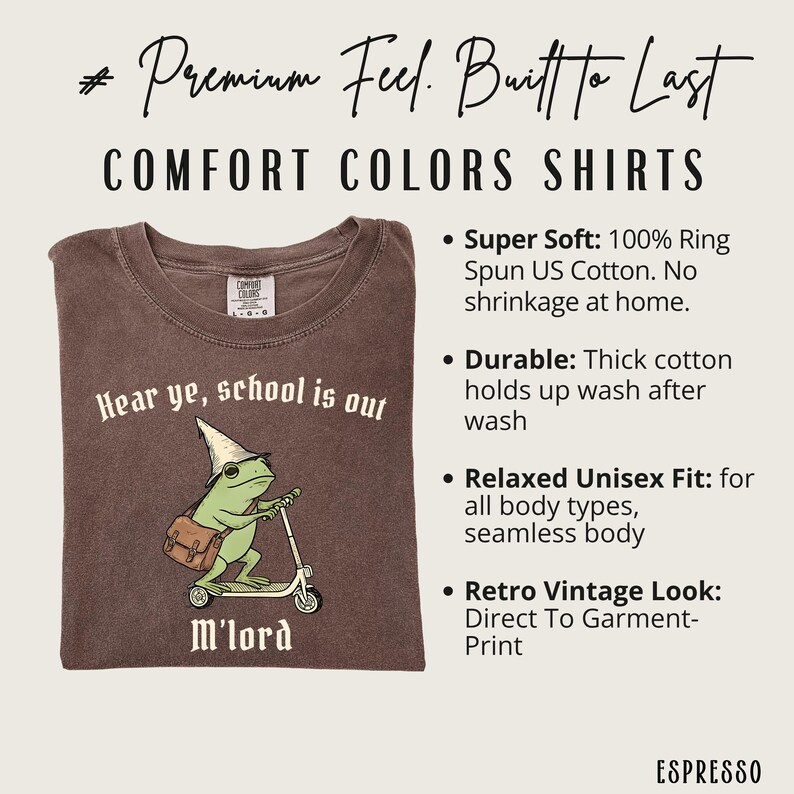 May include: Espresso-colored Comfort Colors t-shirt with a graphic of a frog on a scooter, wearing a wizard hat and carrying a satchel. Text reads "Hear ye, school is out" and "M'lord". The shirt is made of 100% ring-spun US cotton.