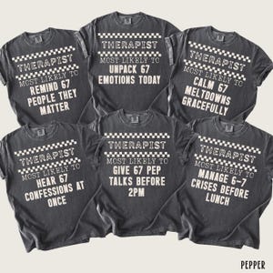 May include: Six dark gray t-shirts with white text and a checkered pattern. Each shirt reads "Therapist Most Likely To" followed by a different humorous statement about a therapist's daily tasks. The shirts are displayed on a neutral background.