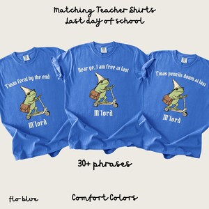 May include: Three flo-blue Comfort Colors t-shirts with a frog graphic riding a scooter. Each shirt has a different phrase: "T'was feral by the end", "Hear ye, I am free at last", and "T'was pencils down at last". The text "M'lord" is below the frog.