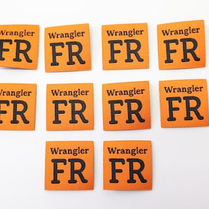 May include: Ten orange fabric labels with the text "Wrangler FR" printed in black.