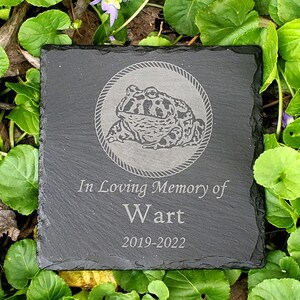 May include: Black slate memorial stone with a frog illustration and the text "In Loving Memory of Wart 2019-2022".