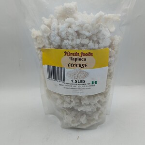 May include: A clear plastic bag filled with coarse tapioca. The bag has a yellow label with the text "Nireds foods Tapioca COARSE" and "1.5 LBS". The tapioca is white and granular.