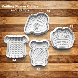 May include: Four white plastic cookie cutters and stamps for knitting-themed treats. Designs include a yarn ball with a crochet hook, a basket of yarn balls, a yarn ball with knitting needles, and a knitted fabric pattern. The text "Knitting Shower Cutters and Stamps" is at the top.