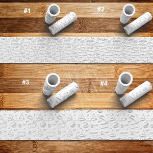 May include: Four white rolling pins with different embossed patterns, including mathematical equations and geometric shapes. The rolling pins are cylindrical with a hollow center. The background is a wooden surface with a white strip of paper with the same patterns.
