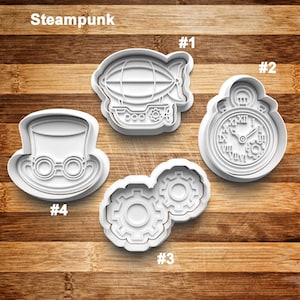May include: Four white plastic cookie cutters with a steampunk theme. The shapes include an airship, a pocket watch, a pair of gears, and a top hat with goggles. The word "Steampunk" is at the top.