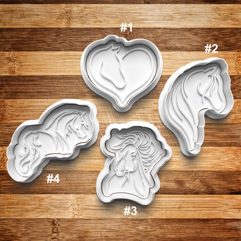 May include: Four white plastic cookie cutters shaped like horses. The cutters are numbered 1 through 4. Cutter #1 is a heart shape with a horse inside. Cutter #2 is a horse's head. Cutter #3 is a horse's head with a mane. Cutter #4 is a horse running.