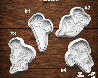 May include: Four white plastic cookie cutters labeled #1 through #4, each featuring a distinct floral design. The cutters are arranged on a dark wood surface. The text "Flowers" appears at the top, and "HB SHACK CREATIONS" is at the bottom right.
