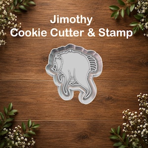 May include: A light gray Jimothy Cookie Cutter & Stamp featuring a stylized bear silhouette. The tool has a defined outer edge for cutting and an inner raised section for stamping the bear design into dough, presented as a single unit.