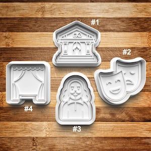 May include: Set of five white plastic cookie cutters shaped like a theater building, a stage curtain, two masks, and a person with a beard. The cutters are numbered 1 through 4.