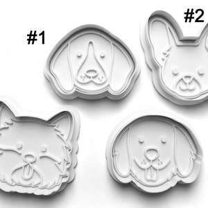 May include: Four white plastic dog cookie cutters, numbered 1 through 4. Each cutter features a different dog breed: Beagle, French Bulldog, Westie, and Golden Retriever.