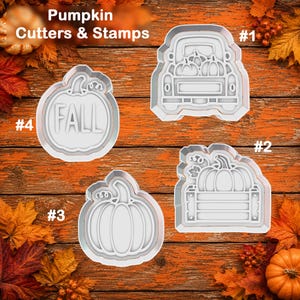 May include: Four white plastic cookie cutters and stamps labeled #1 through #4. Design #1 is a truck with pumpkins, #2 is a pumpkin in a crate, #3 is a simple pumpkin, and #4 is a pumpkin with the text FALL. The set is titled Pumpkin Cutters & Stamps.