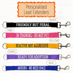 May include: Five personalised dog lead extenders with different coloured straps and messages. The messages are "Friendly but feral", "In training - do not pet", "Reactive not aggressive", "Ready for adoption", and "Anxious - we need space".