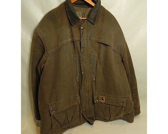 May include: A brown Carhartt work jacket with a corduroy collar and multiple pockets. The jacket has a zipper and button closure.