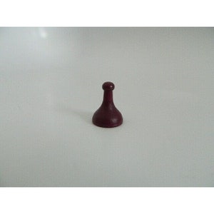May include: A dark purple game piece with a rounded top and a wide base.