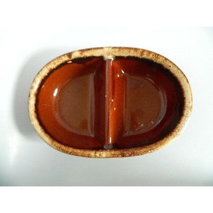 May include: A divided ceramic dish with a brown glaze and a speckled brown and white rim.
