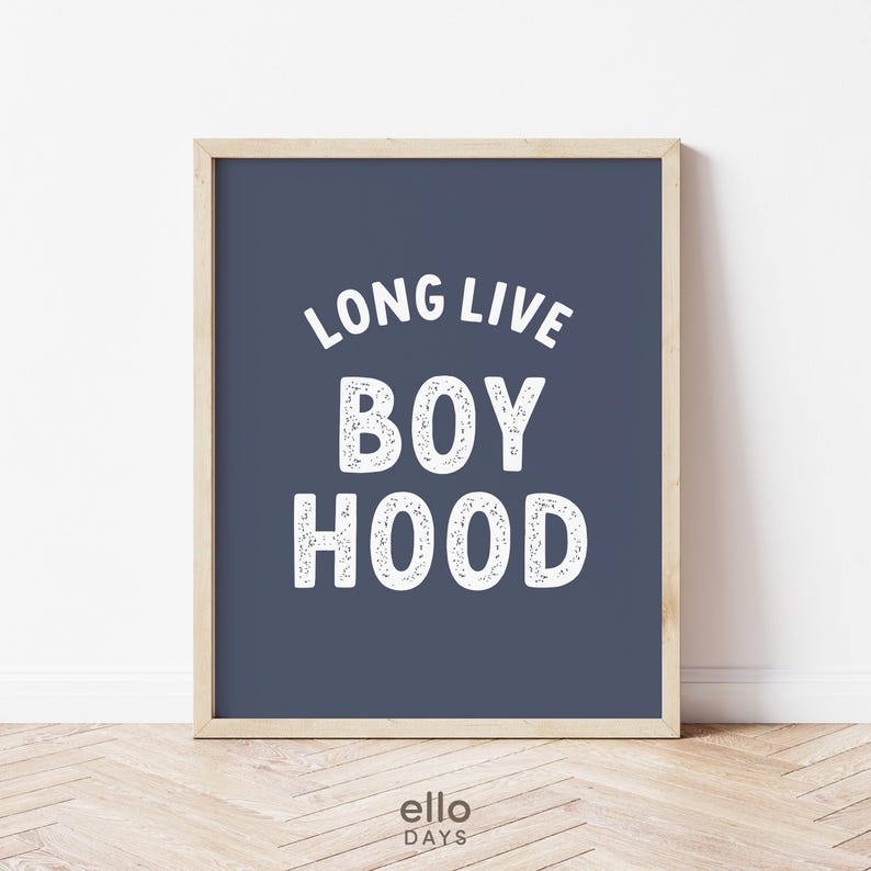 May include: A navy blue framed print with white text that reads "Long Live Boyhood".