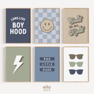 May include: Set of six framed prints with various designs. The prints feature a blue background with white text that says "Long Live Boyhood", a blue and white checkered background with a yellow smiley face, a tan background with brown text that says "Cool to be Kind", a green background with a white lightning bolt, a blue background with white text that says "Rad Little Dude", and a white background with three pairs of sunglasses in different colors.