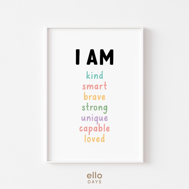 May include: A white framed print with the text "I AM" in black, followed by the words "kind", "smart", "brave", "strong", "unique", "capable", and "loved" in different pastel colours.