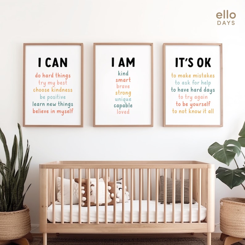 May include: Three framed prints with motivational messages for children. The prints are in a light wood frame and have a white background. The text on the prints is in different colours, including pink, blue, and yellow. The text on the first print reads "I CAN" and includes phrases like "do hard things", "try my best", "choose kindness", "be positive", "learn new things", and "believe in myself". The text on the second print reads "I AM" and includes phrases like "kind", "smart", "brave", "strong", "unique", "capable", and "loved". The text on the third print reads "IT'S OK" and includes phrases like "to make mistakes", "to ask for help", "to have hard days", "to try again", "to be yourself", and "to not know it all".