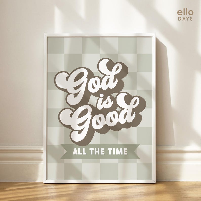May include: A framed print with a green and white checkered background. The text "God is Good" is written in a brown and white retro font. The text "All the Time" is written in a smaller font below the main text.