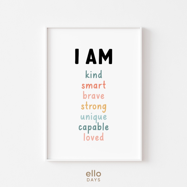 May include: A white framed print with the text "I AM" in black, followed by the words "kind, smart, brave, strong, unique, capable, loved" in various pastel colours.