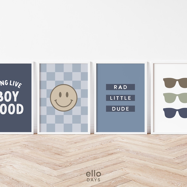 May include: Four blue and white framed prints with different designs. The first print says "Living the Boy Good Life". The second print has a checkered background with a smiley face in the center. The third print says "Rad Little Dude". The fourth print has three pairs of sunglasses in different colors.