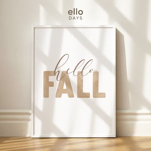 Könnte beinhalten: Ein weißer gerahmter Druck mit dem Text "hello fall" in braunen Buchstaben auf weißem Hintergrund.