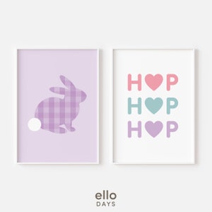 May include: Two printable wall art prints with a pastel color scheme. The first print features a purple bunny silhouette with a gingham pattern. The second print features the word "HOP" repeated three times with a different colored heart in each repetition.