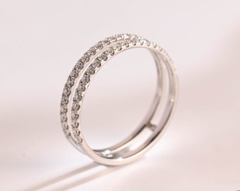 May include: A silver ring with two rows of small, clear stones.