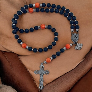 May include: A black lava rock rosary with orange beads and a silver Harley Davidson charm and cross.