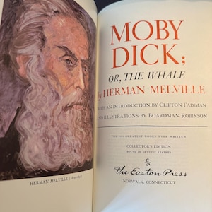 Może przedstawiać: Otwarta książka z tytułem "MOBY DICK" w czerwonych literach. Imię i nazwisko autora, Herman Melville, r&oacute;wnież w kolorze czerwonym. Portret Hermana Melville'a znajduje się na lewej stronie. Książka jest wydaniem kolekcjonerskim The Easton Press.