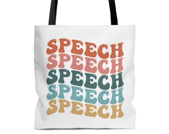 May include: White tote bag with black handles featuring the word "SPEECH" in a repeating, retro-style design. The word is in various colors, including orange, pink, teal, and tan. The bag is designed for carrying items.