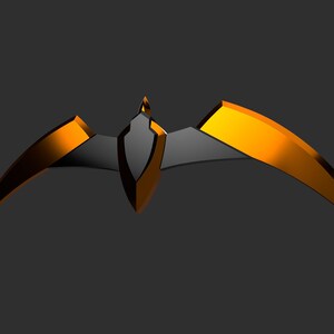 May include: A stylized, geometric headpiece in a bat-wing design. The headpiece features a central black shield shape with a pointed top, flanked by curved, gold-colored wings. The design is set against a dark gray background.