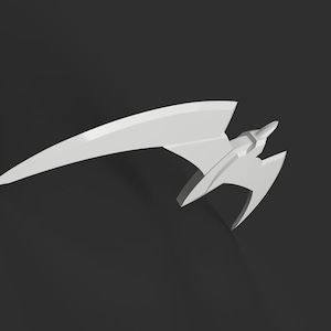 May include: A white, stylized, geometric sculpture resembling a futuristic aircraft or weapon. The design features a long, curved wing and a central body with angular elements. The object is set against a dark background.