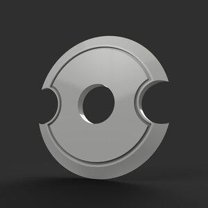May include: A 3D-rendered, silver-colored, circular object with a central hole and two curved cutouts on opposite sides. The object has a glossy finish and is set against a dark gray background.