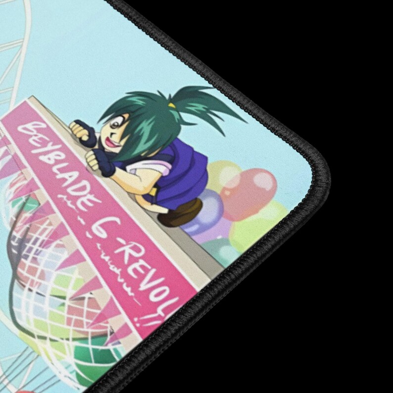 May include: A mousepad featuring a colorful anime-style illustration. The design includes a character with green hair and a blue outfit, along with the text "Beyblade G-REVOLUTION!!" on a pink banner. The background has a light blue sky and colorful balloons.