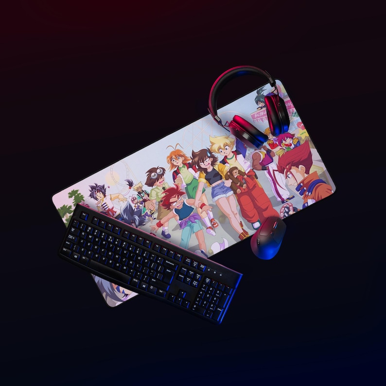 May include: A gaming setup featuring a black keyboard with blue backlighting, a mouse, and a headset. The setup includes a large mousepad with a colorful anime-style illustration of several characters. The background is dark.
