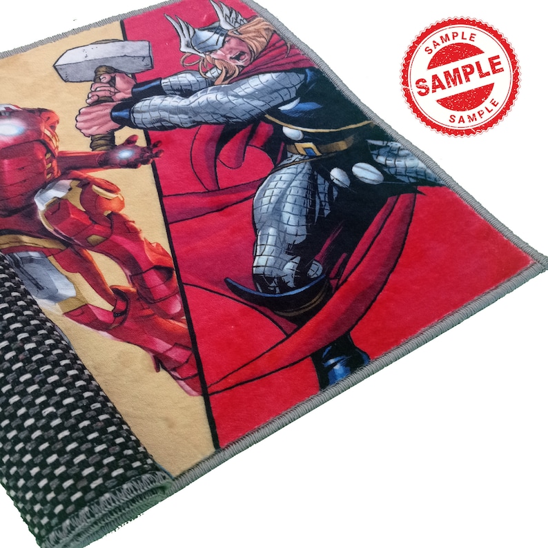 May include: A red and yellow rug with a comic book image of Thor and Iron Man. The rug has a gray border and a black and white checkered backing.