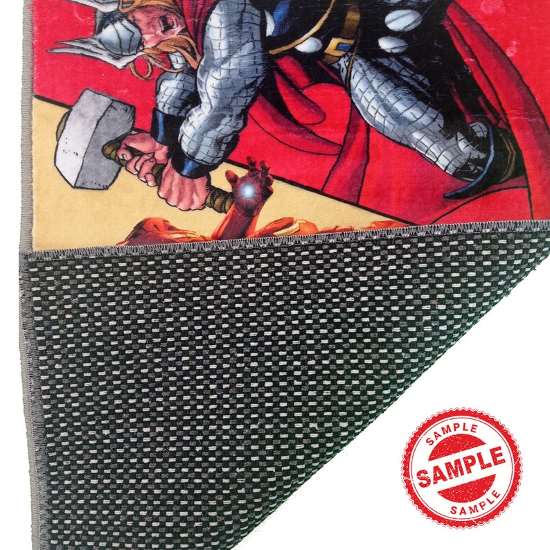 May include: A red, yellow, and black comic book style rug featuring a superhero with a hammer. The rug has a non-slip backing.