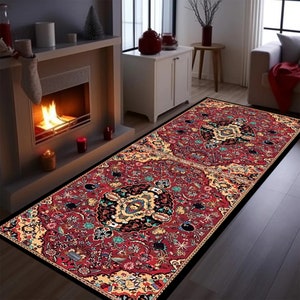 May include: A red, black, and gold patterned rug with a black border. The rug has a traditional Persian design with intricate details.