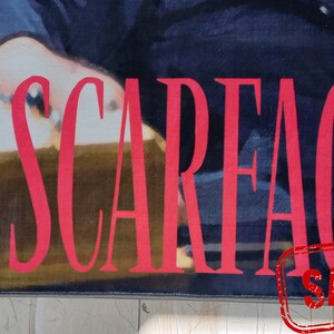 May include: A red and white poster with the word "SCARFACE" in large, bold, red letters. The poster is a sample.