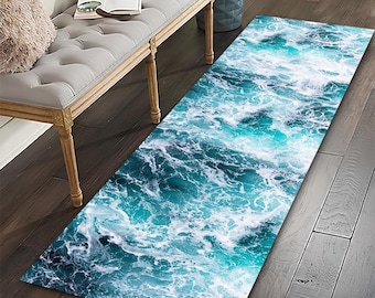 May include: A rectangular rug with a vibrant ocean wave design. The rug features shades of teal and white, mimicking the movement of water. It is placed on a dark wood floor, adding a touch of coastal decor to the space.