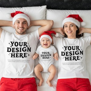 May include: A family wearing matching white t-shirts and red bottoms, with Santa hats. The shirts and onesie have the text "YOUR DESIGN HERE". The image is a mockup for custom family Christmas apparel.