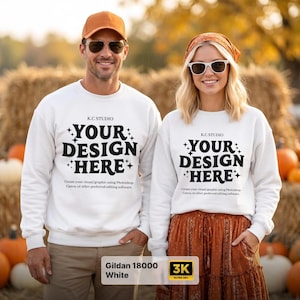 May include: Two white crewneck sweatshirts featuring the black text K.C. STUDIO, YOUR DESIGN HERE, and smaller text below. The sweatshirts are worn by two individuals, one in a tan baseball cap and sunglasses, the other in a headscarf and sunglasses.