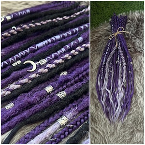 May include: A collection of purple, black, and silver dreadlocks. Some dreads are braided, others are twisted, and some have silver metal accents. The dreadlocks are tied together with twine.